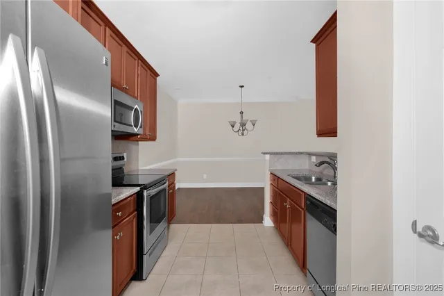 a kitchen with stainless steel appliances granite countertop a refrigerator and a stove