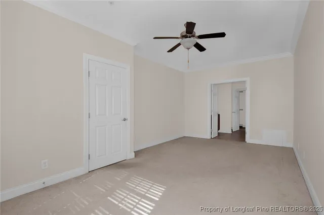 a view of empty room with ceiling fan