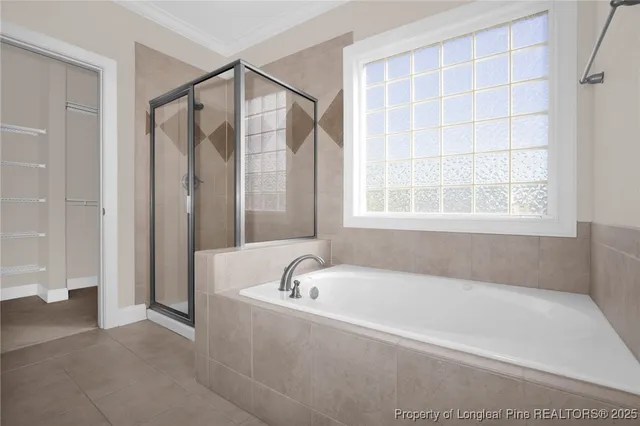 a white bath tub sitting next to a shower