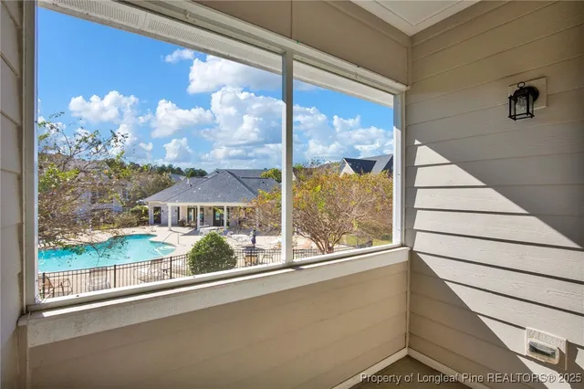 a view of a window with a flower garden