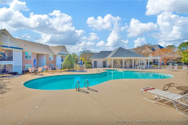 a view of house with outdoor space and swimming pool