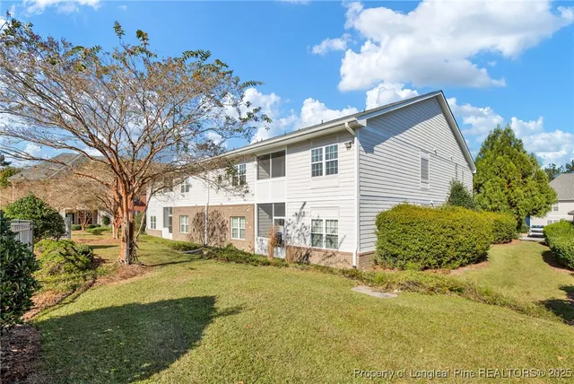 a view of a house with a backyard