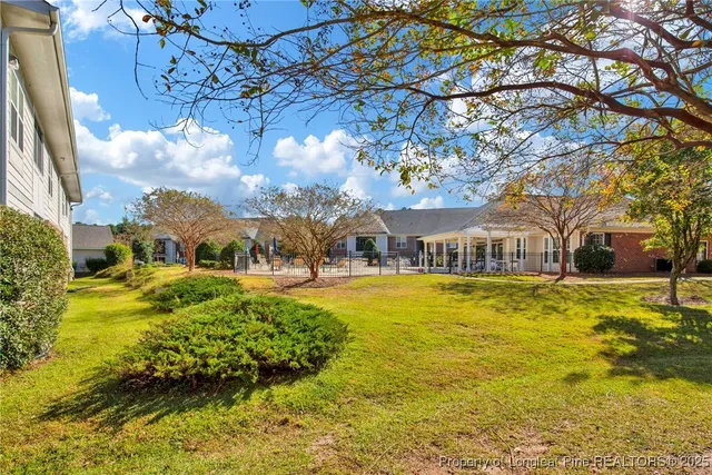 a view of a house with a yard covered with snow