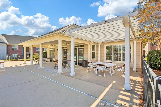 a view of a patio with dining table and chairs with wooden floor