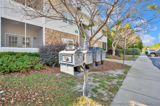 a white house covered with tall trees