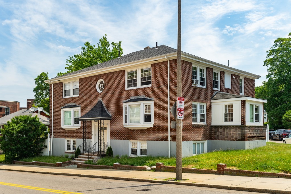440 Adams Street, Unit 1 Boston, MA 02122 - Photo 13 of 14 a front view of a house with a yard