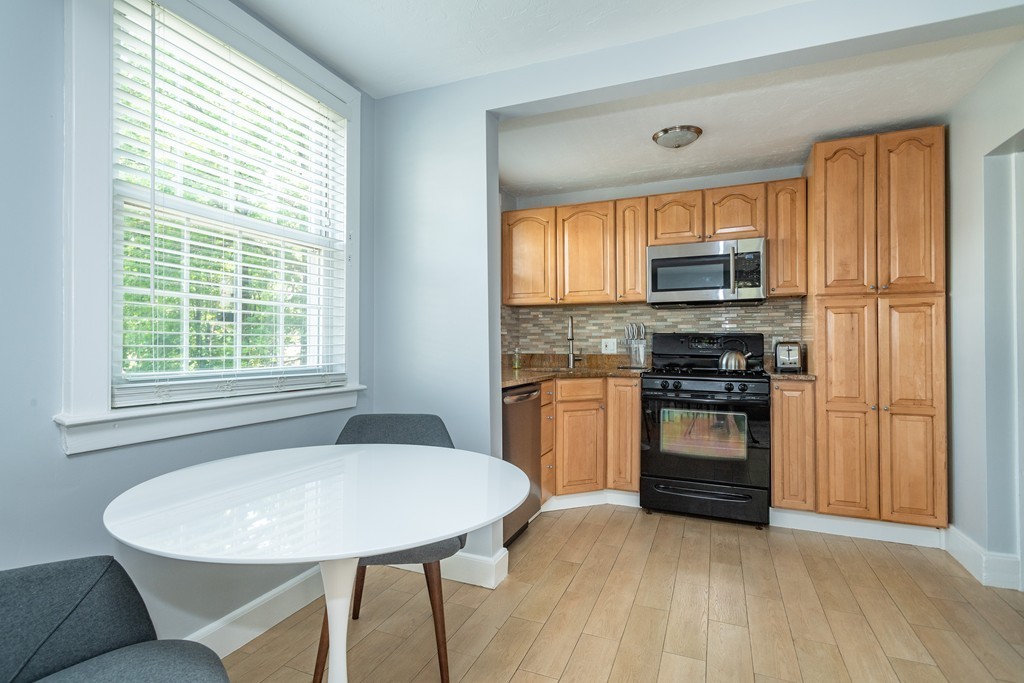 440 Adams Street, Unit 1 Boston, MA 02122 - Photo 2 of 14 a kitchen with appliances cabinets and a sink
