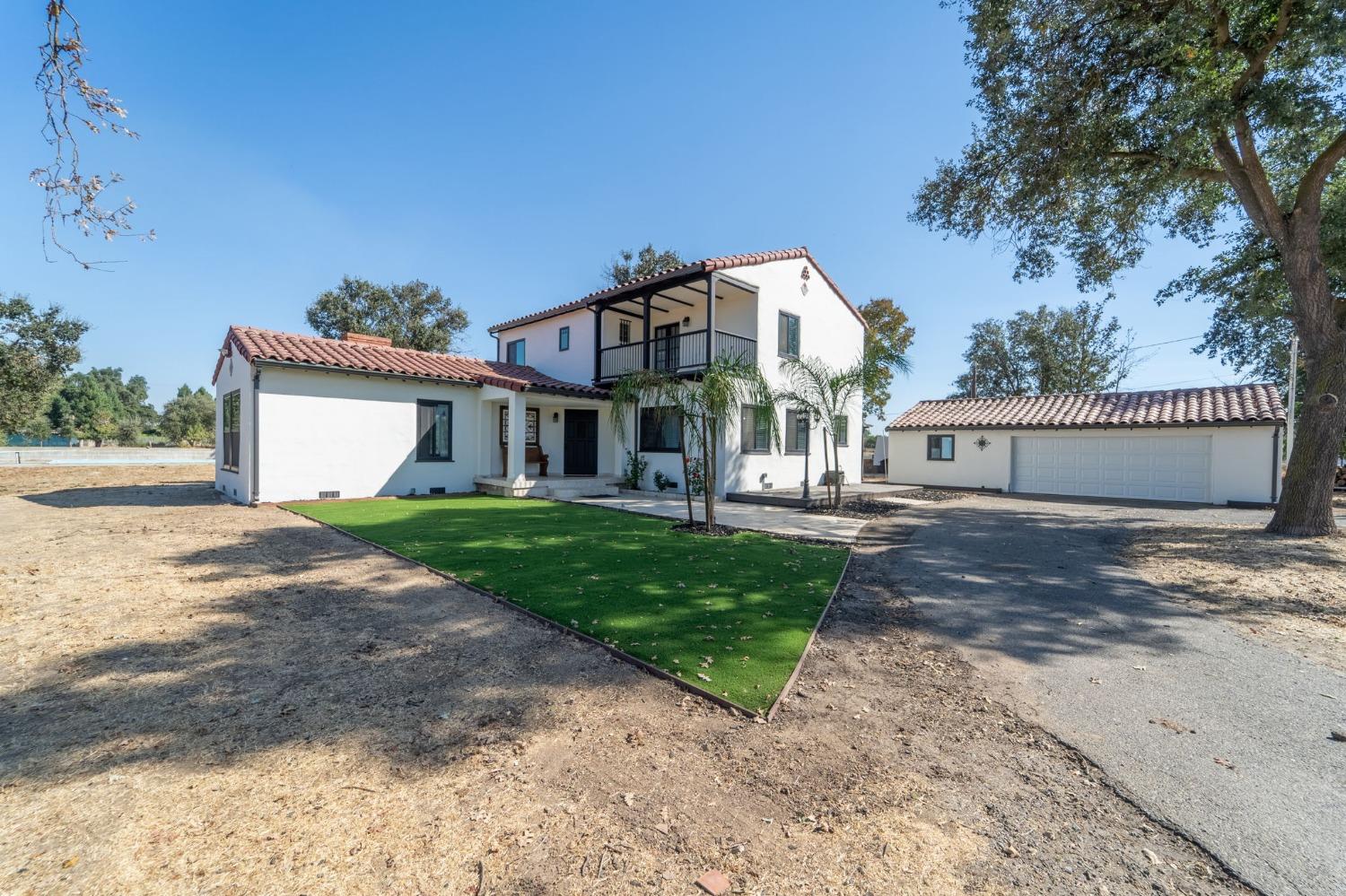 a front view of a house with a yard and a garage