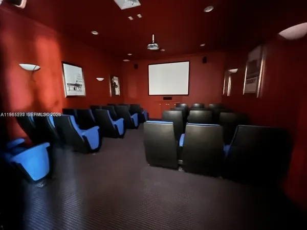 a media room with lots of chairs and a projector