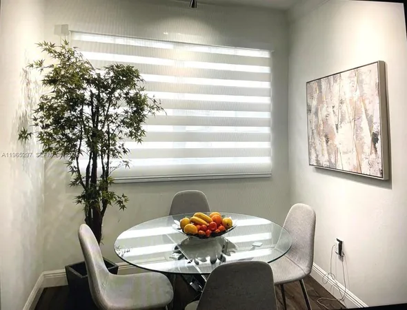 a dining room with furniture and window