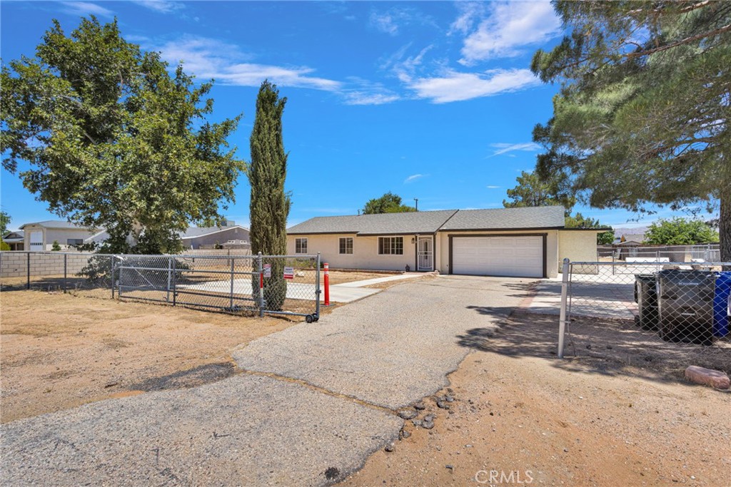 15471 Washoan Road Apple Valley, CA 92307 - Photo 2 of 38 a front view of a house with a yard and garage
