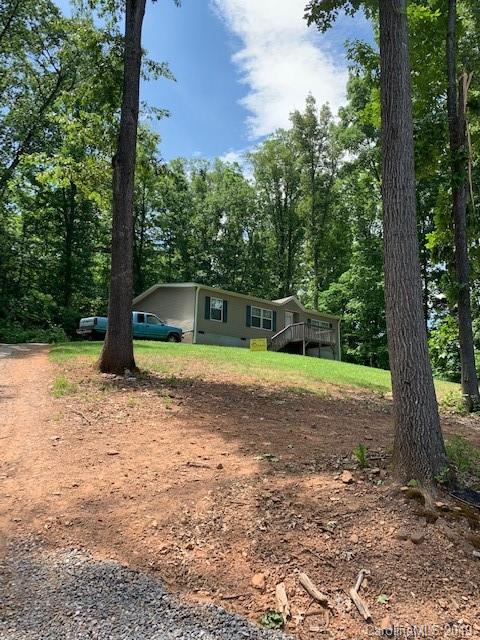 49 Ballard Ridge Road Leicester, NC 28748 - Photo 8 of 21 a view of a yard with potted plants and large trees