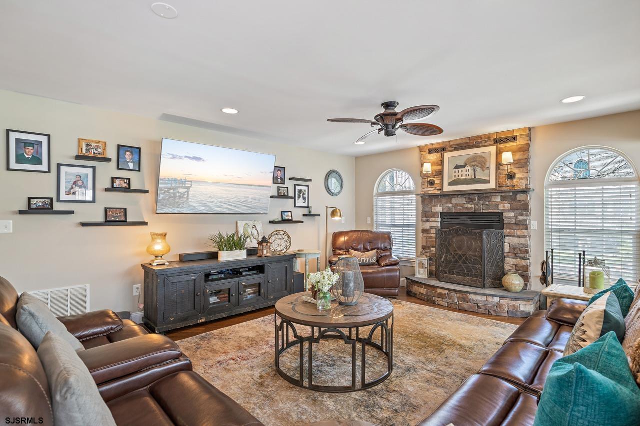 344 Old New York Road Port Republic, NJ 08241 - Photo 51 of 99 a living room with furniture a fireplace and a flat screen tv