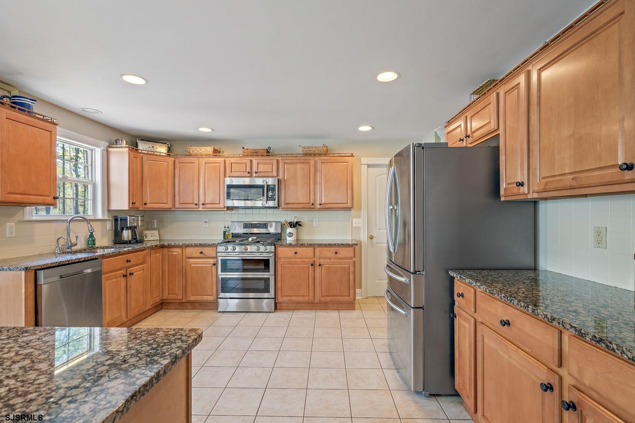 344 Old New York Road Port Republic, NJ 08241 - Photo 55 of 99 a kitchen with stainless steel appliances granite countertop a refrigerator stove top oven and sink