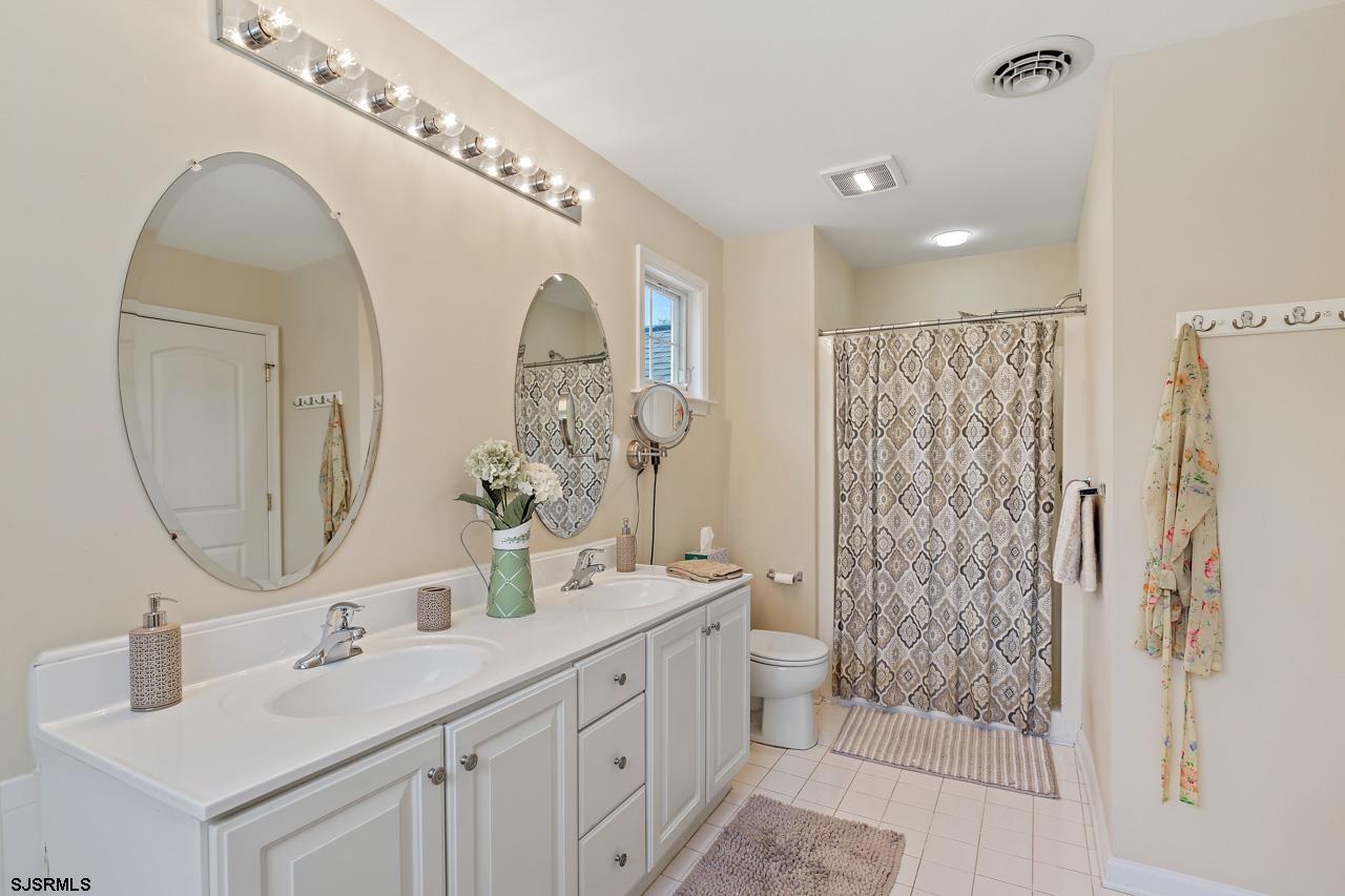 344 Old New York Road Port Republic, NJ 08241 - Photo 71 of 99 a bathroom with a double vanity sink mirror and shower