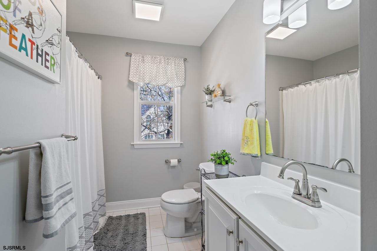 344 Old New York Road Port Republic, NJ 08241 - Photo 75 of 99 a bathroom with a granite countertop toilet a sink and a mirror