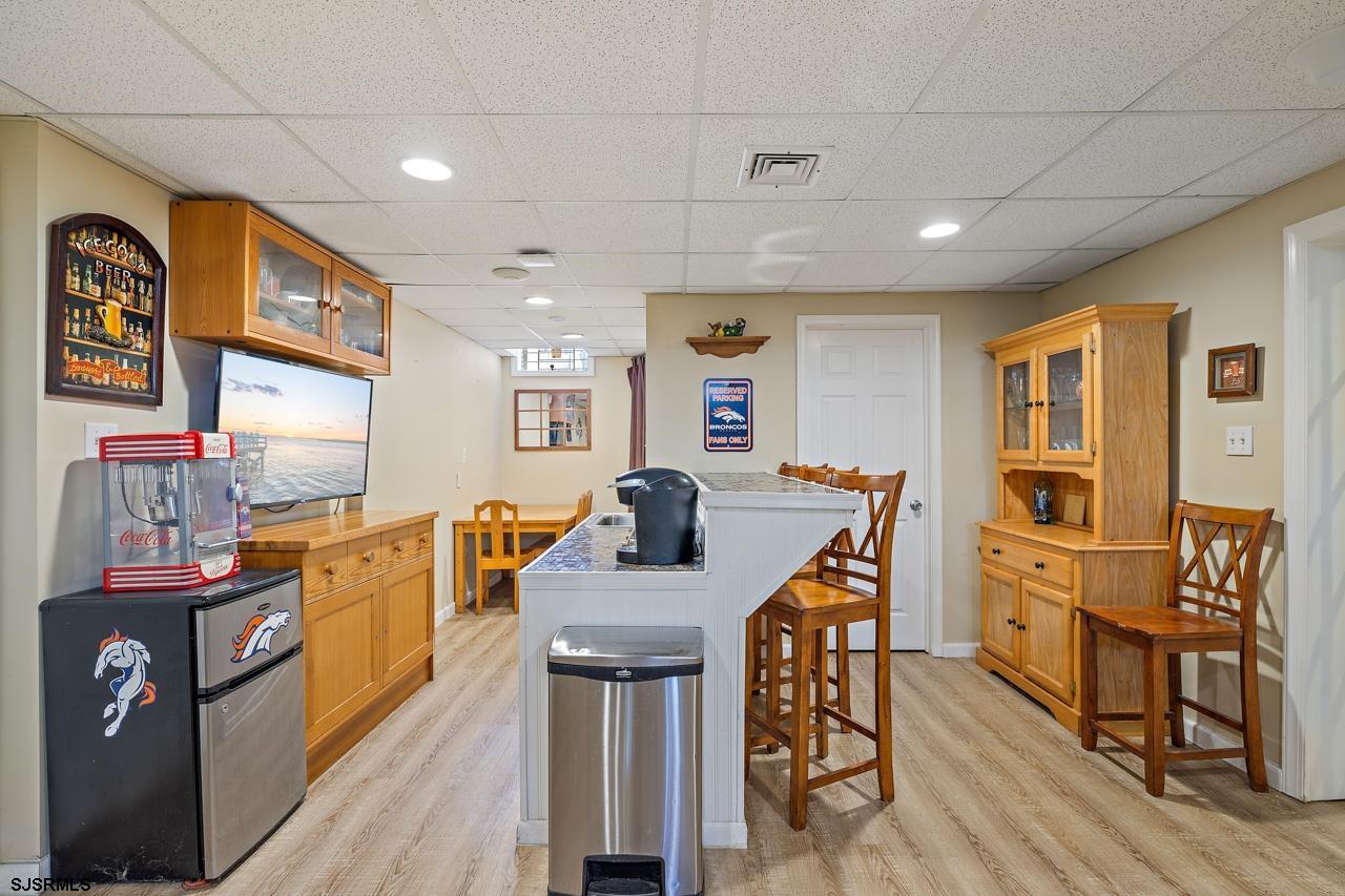 344 Old New York Road Port Republic, NJ 08241 - Photo 82 of 99 a kitchen with stainless steel appliances granite countertop a stove top oven a sink a dining table and chairs with wooden floor