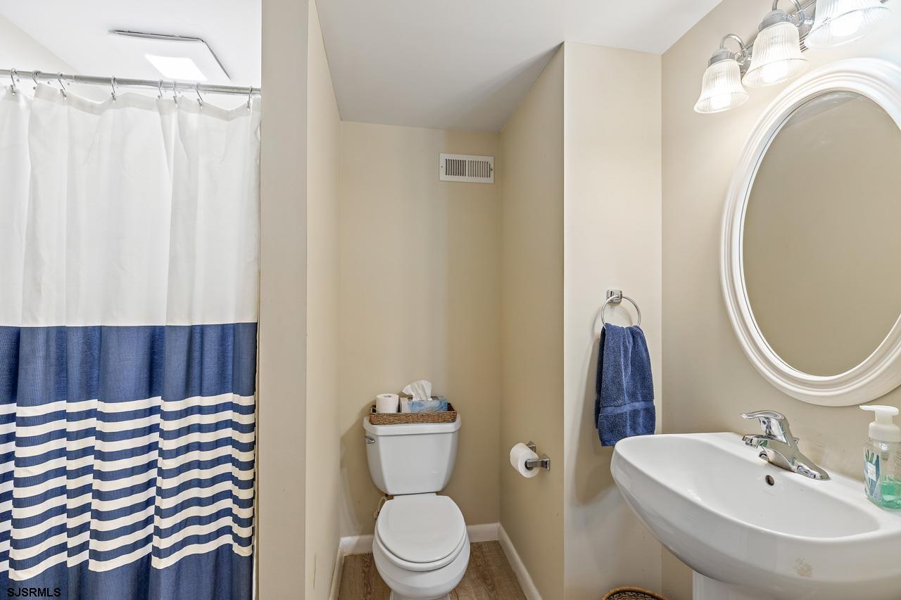 344 Old New York Road Port Republic, NJ 08241 - Photo 88 of 99 a bathroom with a sink a toilet and a mirror