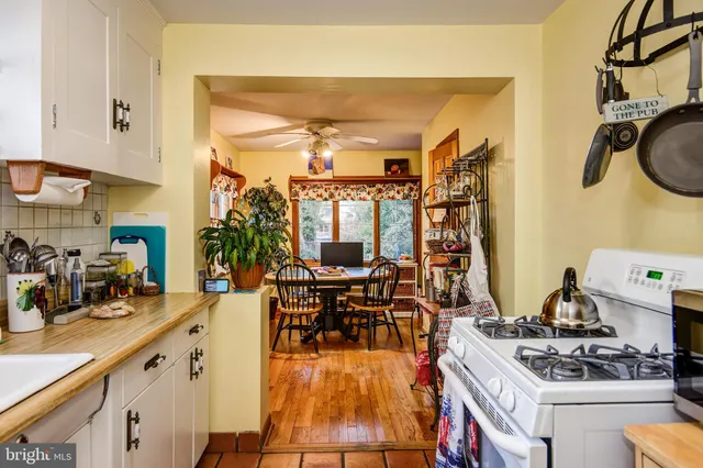 a kitchen with stainless steel appliances granite countertop a stove and white cabinets