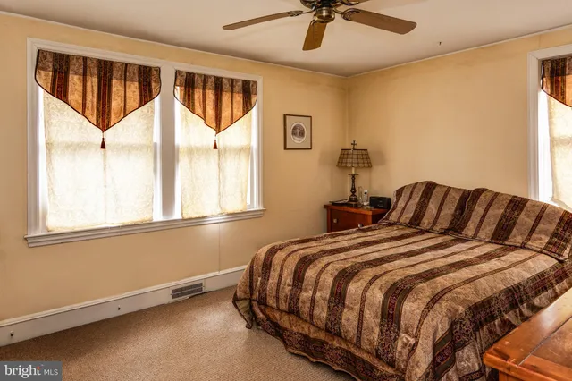 a bed sitting in a bedroom next to a window