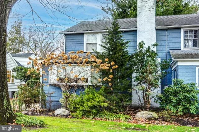 a view of a house with garden and statue