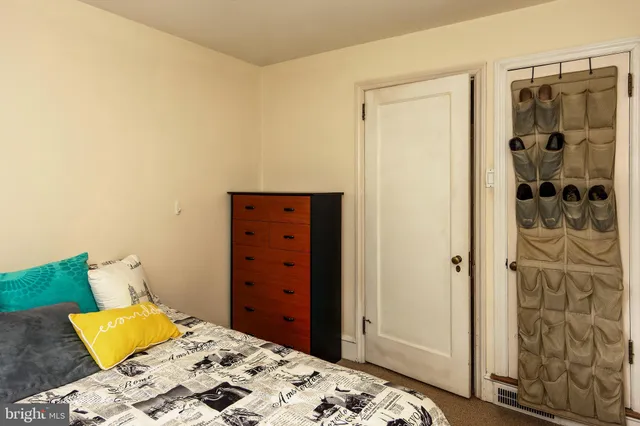 a bedroom with a bed and a dresser in it