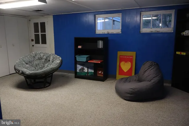 a living room with furniture and a mirror