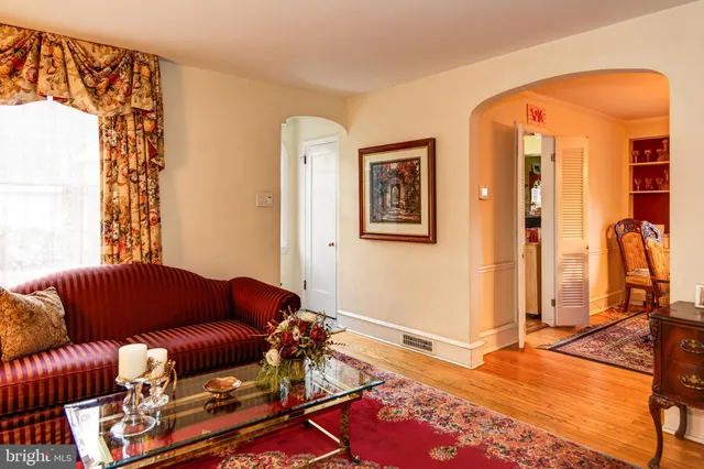 a blue couch sitting in a living room next to a window