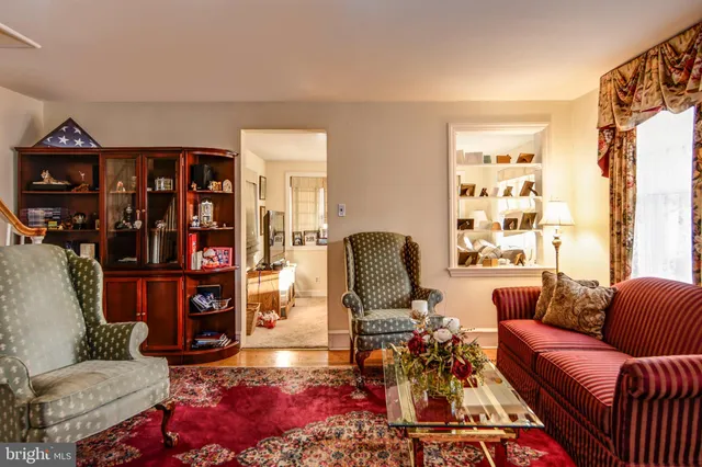 a living room with furniture a rug and a window