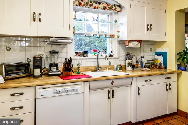 a kitchen with sink refrigerator and cabinets