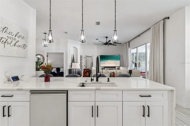 a kitchen with stainless steel appliances a sink stove and refrigerator