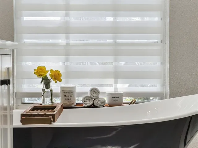 a view of a livingroom with lounge chair and a window