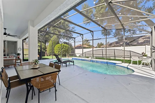 a view of a dining room with furniture a chandelier and wooden floor