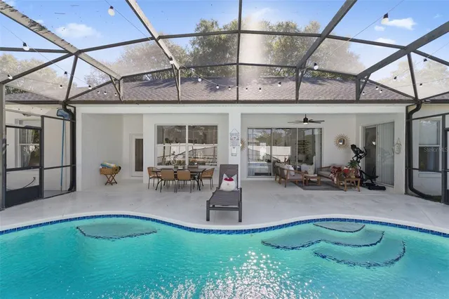 a view of a swimming pool with outdoor seating