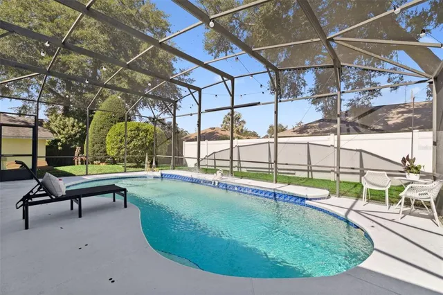 a view of a patio with table and chairs potted plants and large tree
