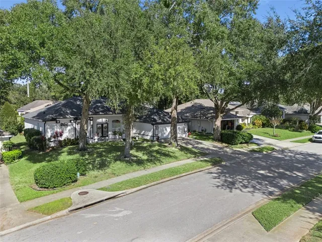 an aerial view of a house with a yard and garden