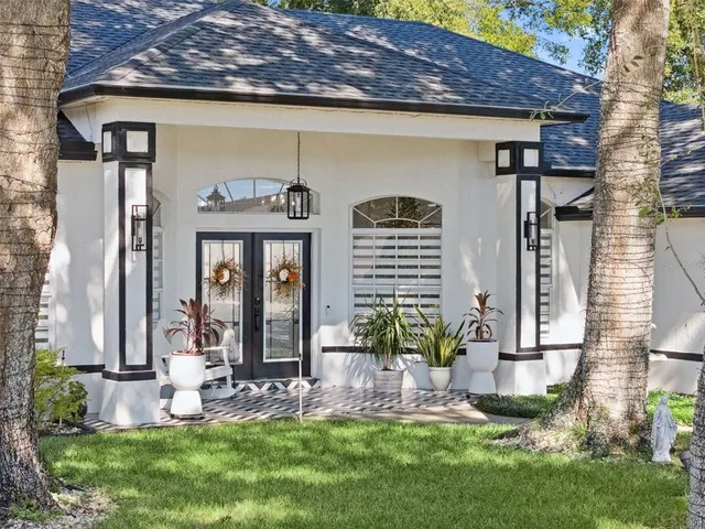 a front view of a house with a yard table and chairs