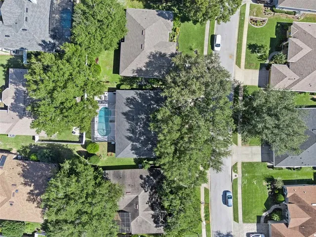 an aerial view of a house with a yard