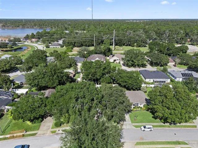 an aerial view of a houses with a yard