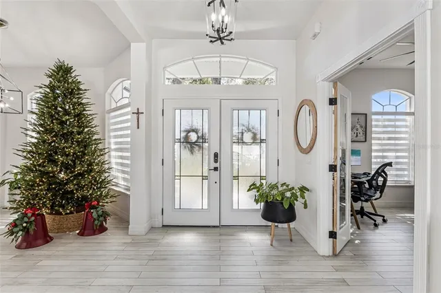 a vase of flowers sitting on a wooden floor