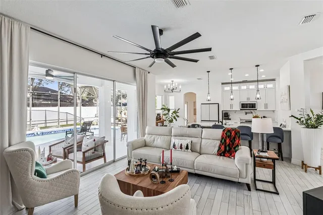 a living room with furniture a rug and a flat screen tv