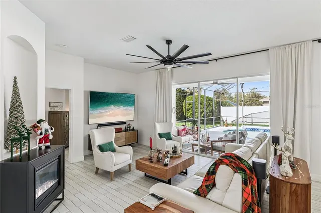 a kitchen with stainless steel appliances a sink a stove a refrigerator with white cabinets and wooden floor