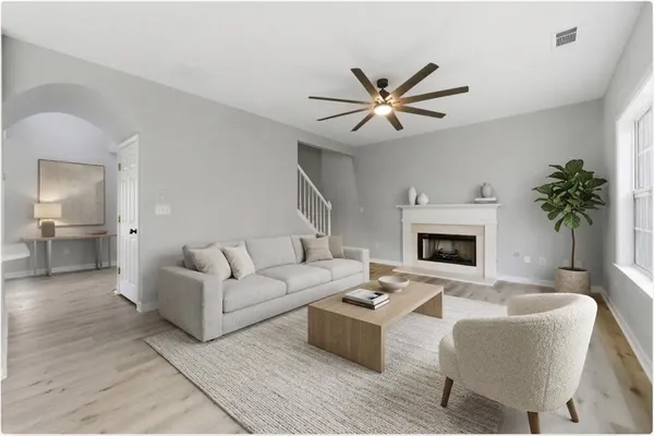 a view of an empty room with a window and wooden floor