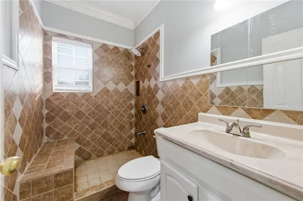 a bathroom with a double vanity sink a mirror and a bathtub