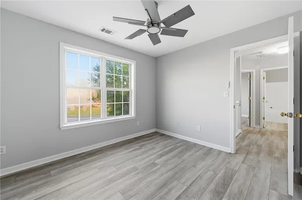 a bedroom with a bed and a potted plant