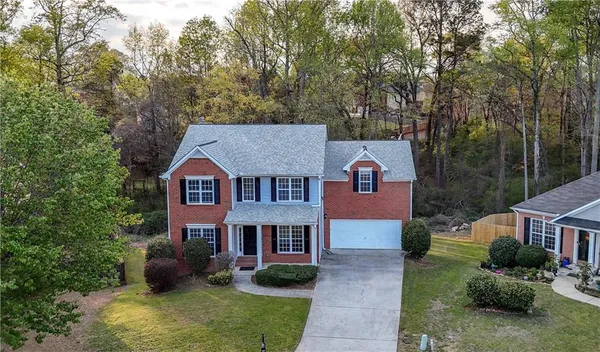 an aerial view of a house with outdoor space