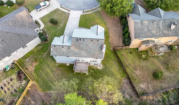 a kitchen with stainless steel appliances granite countertop a stove top oven a sink dishwasher a dining table and chairs with wooden floor