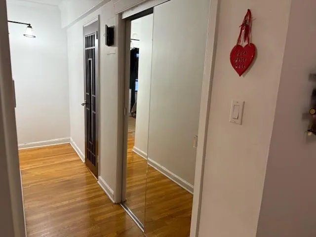 a view of a hallway with wooden floor