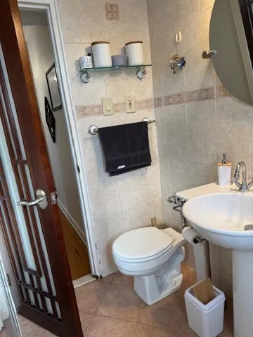 a bathroom with a sink a toilet and a mirror