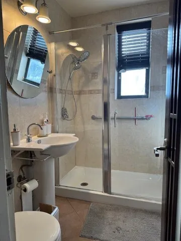 a bathroom with a sink a toilet and shower